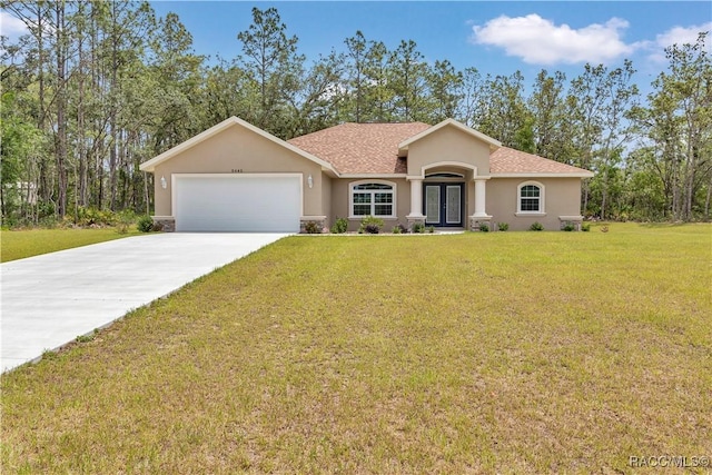 5443 N Nakoma Dr, Beverly Hills, FL 34465 - view of front of property featuring french doors, stucco siding, a garage, a front yard, and driveway