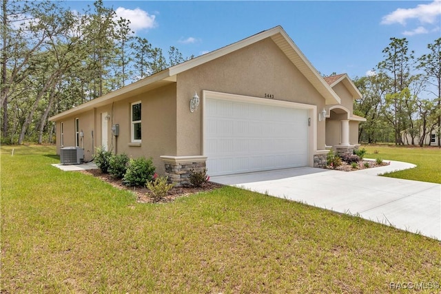 5443 N Nakoma Dr, Beverly Hills, FL 34465 - view of side of home with stucco siding, stone siding, a garage, driveway, and a yard