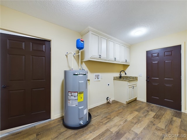 laundry area with washer hookup, hookup for an electric dryer, water heater, hardwood / wood-style floors, and a textured ceiling