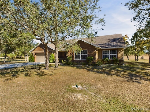 single story home featuring a front yard and a garage