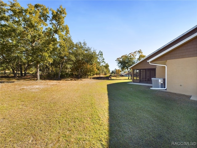 view of yard featuring a sunroom and cooling unit