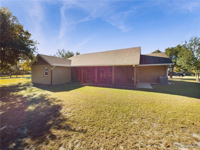 view of property exterior with central AC unit and a lawn