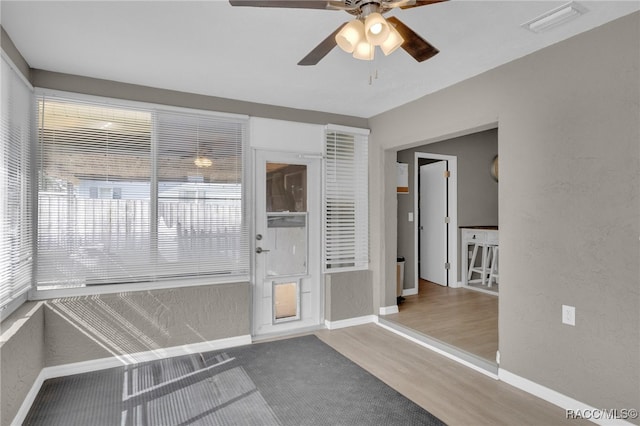 interior space with hardwood / wood-style flooring and ceiling fan