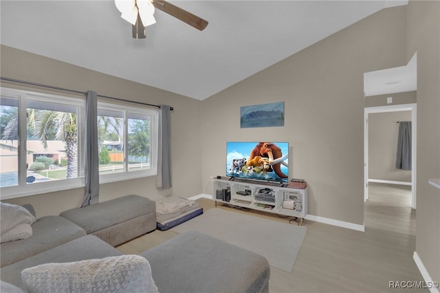 living room featuring ceiling fan, lofted ceiling, and light wood-type flooring