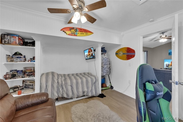 bedroom featuring ceiling fan, crown molding, and light hardwood / wood-style floors