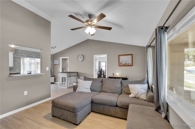 living room featuring light wood-type flooring, vaulted ceiling, and ceiling fan