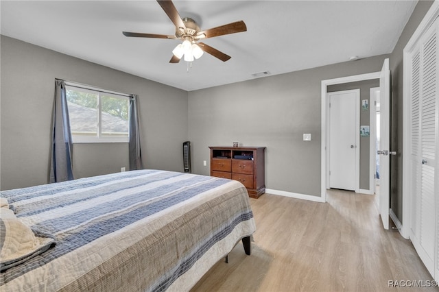 bedroom featuring light wood-type flooring, a closet, and ceiling fan