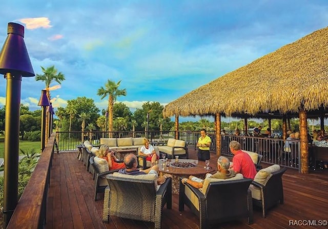 deck featuring a gazebo and an outdoor living space with a fire pit