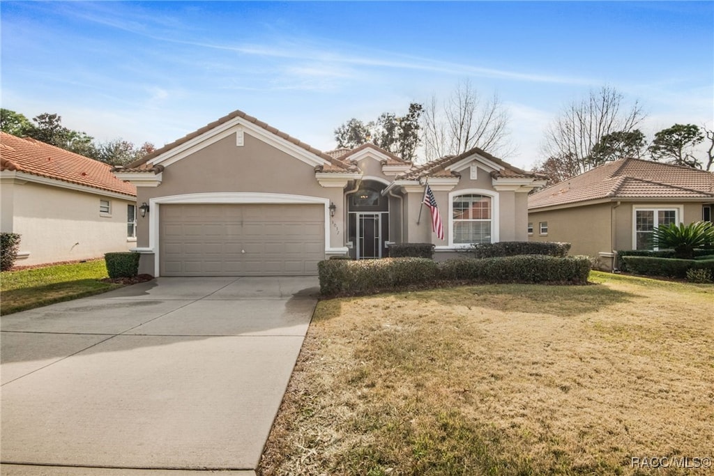 view of front of home with a garage and a front yard