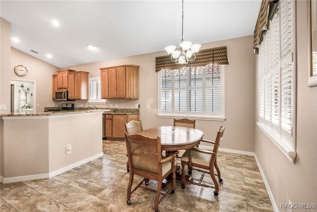 dining area with lofted ceiling and a chandelier