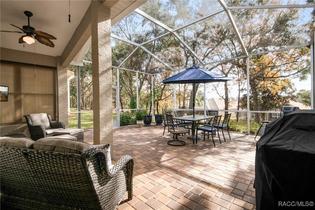 view of patio / terrace with grilling area, a lanai, and ceiling fan