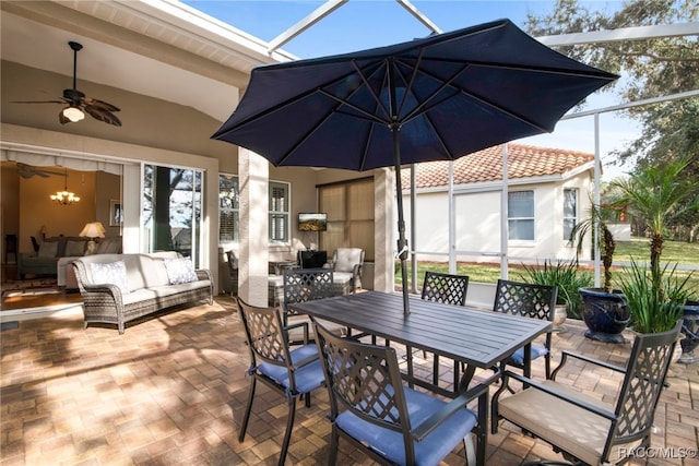 view of patio with an outdoor living space, a lanai, and ceiling fan