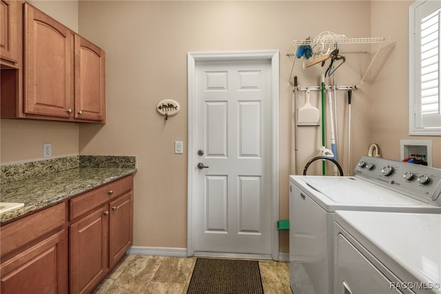 washroom featuring cabinets and separate washer and dryer