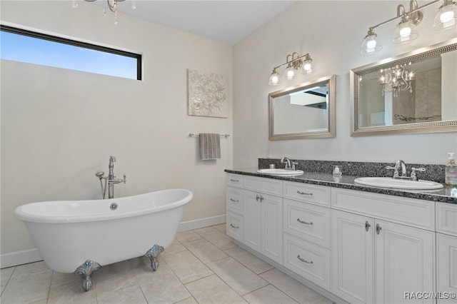 bathroom with tile patterned flooring, vanity, and a tub