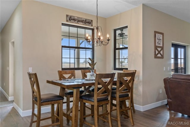 dining room with hardwood / wood-style floors and an inviting chandelier