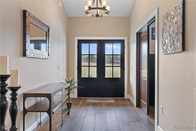 foyer with a chandelier and french doors