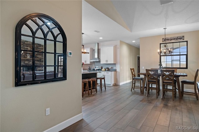 dining room with vaulted ceiling, dark hardwood / wood-style flooring, and a chandelier