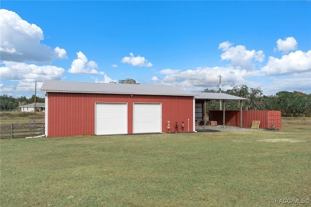 view of outbuilding with a lawn and a garage