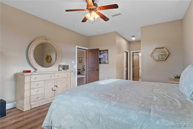 bedroom with hardwood / wood-style floors and ceiling fan