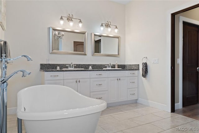 bathroom with vanity, tile patterned floors, and a tub