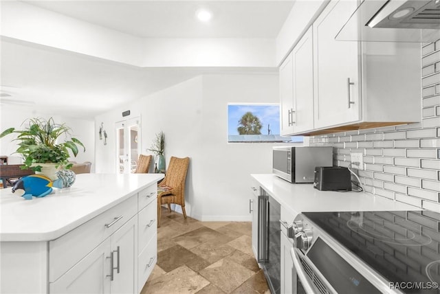 kitchen featuring appliances with stainless steel finishes, white cabinets, backsplash, and french doors