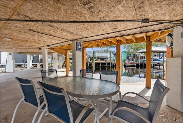 view of patio / terrace featuring a water view and a dock