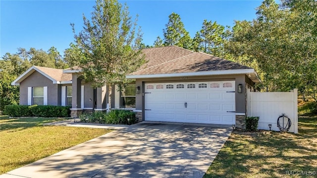 single story home featuring a garage and a front lawn