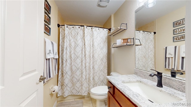 bathroom featuring vanity, tile patterned flooring, toilet, a textured ceiling, and curtained shower