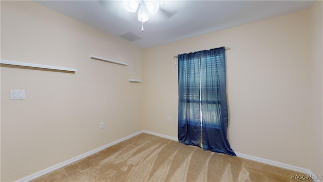 spare room with light carpet and ceiling fan