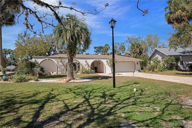 view of front of property with driveway, a front lawn, and an attached garage