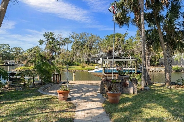 view of yard with a boat dock and a water view