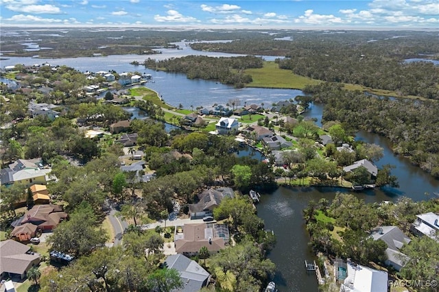 birds eye view of property with a water view and a residential view