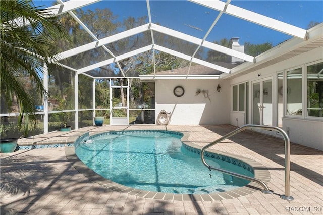 pool with a lanai and a patio