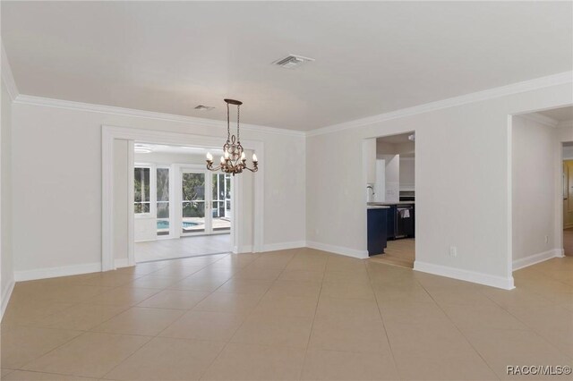 spare room with light tile patterned floors, baseboards, visible vents, crown molding, and a notable chandelier