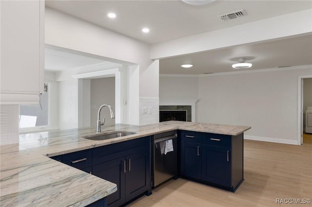 kitchen with visible vents, a sink, a peninsula, and dishwasher