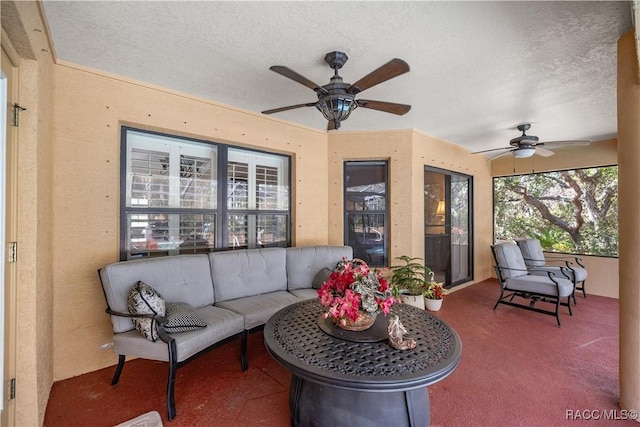 sunroom / solarium featuring a ceiling fan