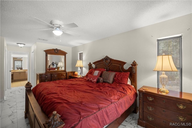 bedroom with marble finish floor, visible vents, and a textured ceiling