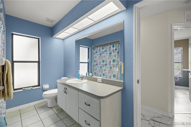 full bath featuring toilet, visible vents, vanity, baseboards, and marble finish floor