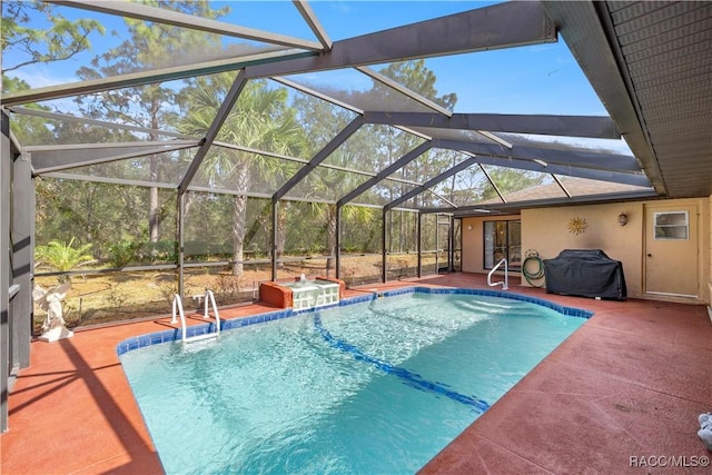 pool featuring a lanai, a patio area, and a hot tub