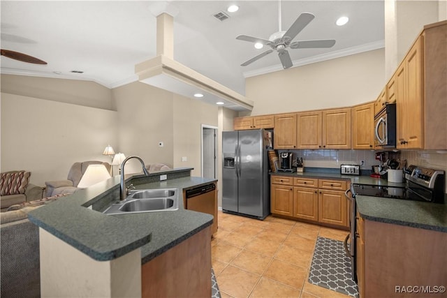 kitchen with a sink, open floor plan, appliances with stainless steel finishes, tasteful backsplash, and dark countertops