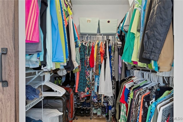 walk in closet featuring tile patterned flooring