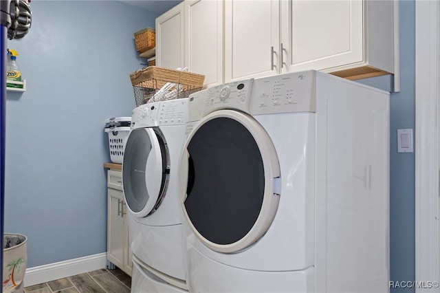 laundry area featuring cabinets and washing machine and dryer