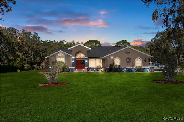 ranch-style house with a yard