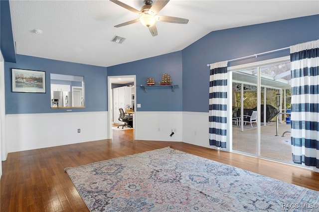 interior space with ceiling fan, hardwood / wood-style floors, and lofted ceiling