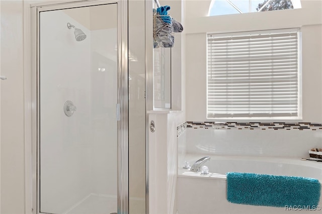 bathroom featuring separate shower and tub