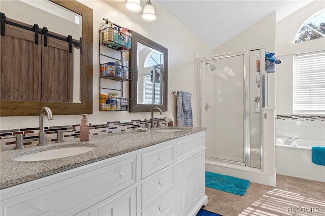 bathroom with backsplash, tile patterned flooring, lofted ceiling, and independent shower and bath