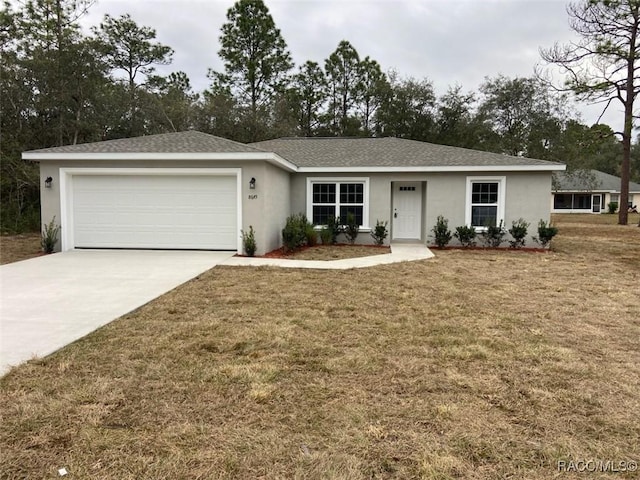 ranch-style home featuring a front lawn and a garage