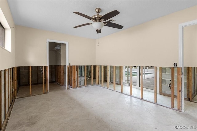 unfurnished room with a wealth of natural light and ceiling fan