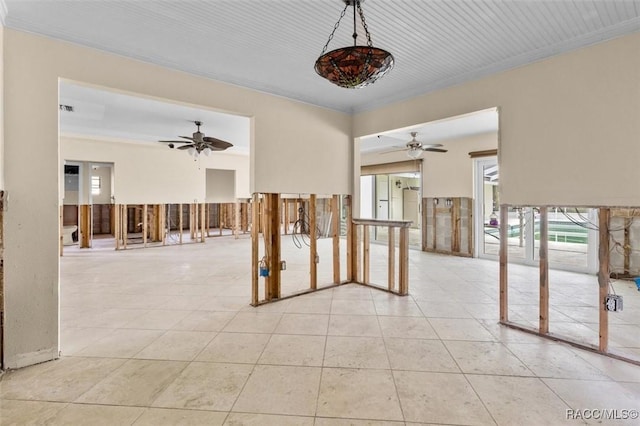 spare room with light tile patterned floors, ceiling fan, and ornamental molding