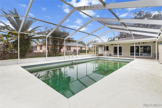 view of pool with a lanai, a patio area, and ceiling fan